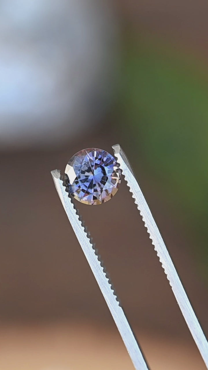 Watch this untreated 1.72 carat Merelani Hills tanzanite display an extraordinary blend of blue, violet, green, and golden-orange hues through its precision custom round mixed cut.