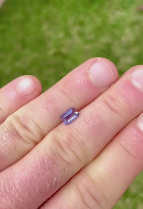 Video showcasing the Royal Amethyst No Heat Sapphire, emphasizing its unique cut and the light interaction with its purple surface, demonstrating the gemstone's clarity and sparkle.