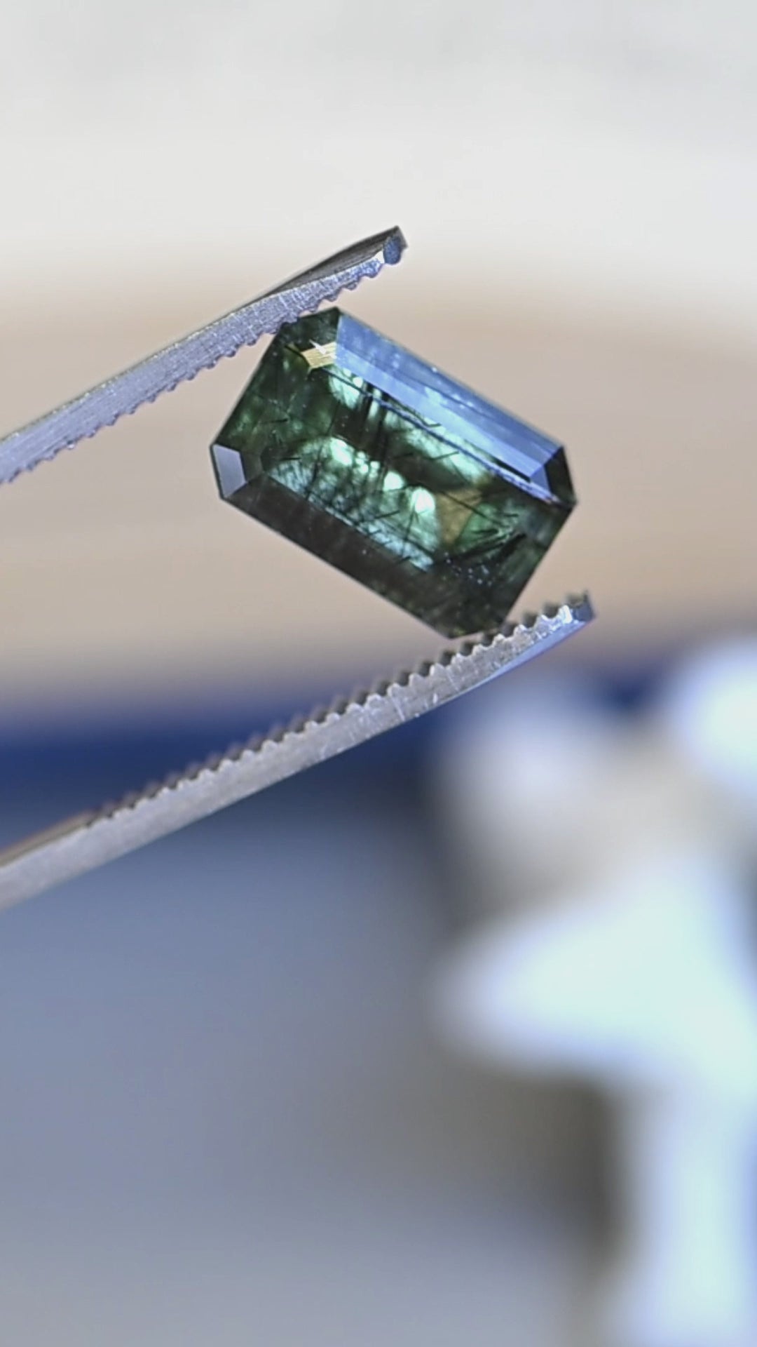 Watch this untreated 6.00 carat peridot from Skardu, Pakistan rotate in natural light, revealing its deep forest green color, elongated step mix cut, and remarkable natural needle inclusions.