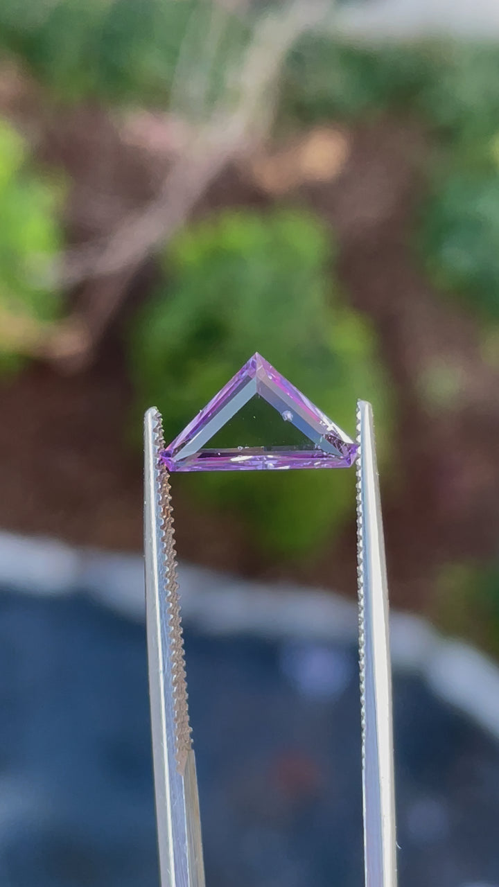 A stunning 1.02-carat pink and lavender Spinel gemstone in a modified trillion portrait cut, ethically sourced from Sri Lanka.