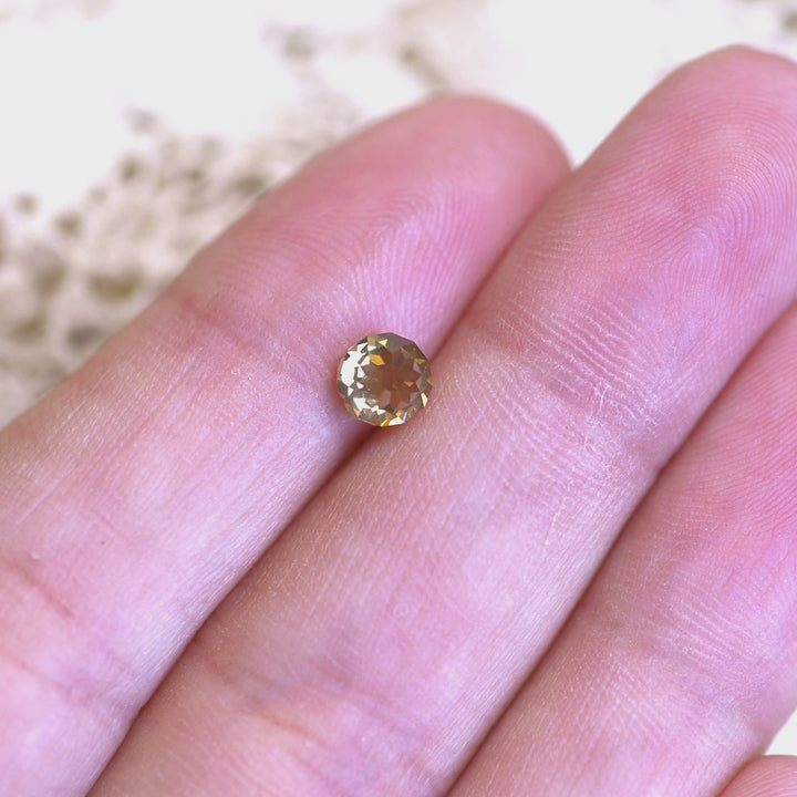 0.93ct Mughal cut champagne diamond rotated in hand, revealing warm golden flashes and antique-style faceting.