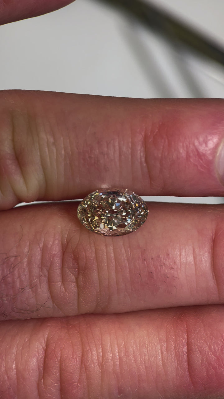 A 360-degree video showcasing a 3.01-carat antique-style old mine moval diamond in fancy light brown champagne, revealing its flawless clarity and vintage-inspired cut.