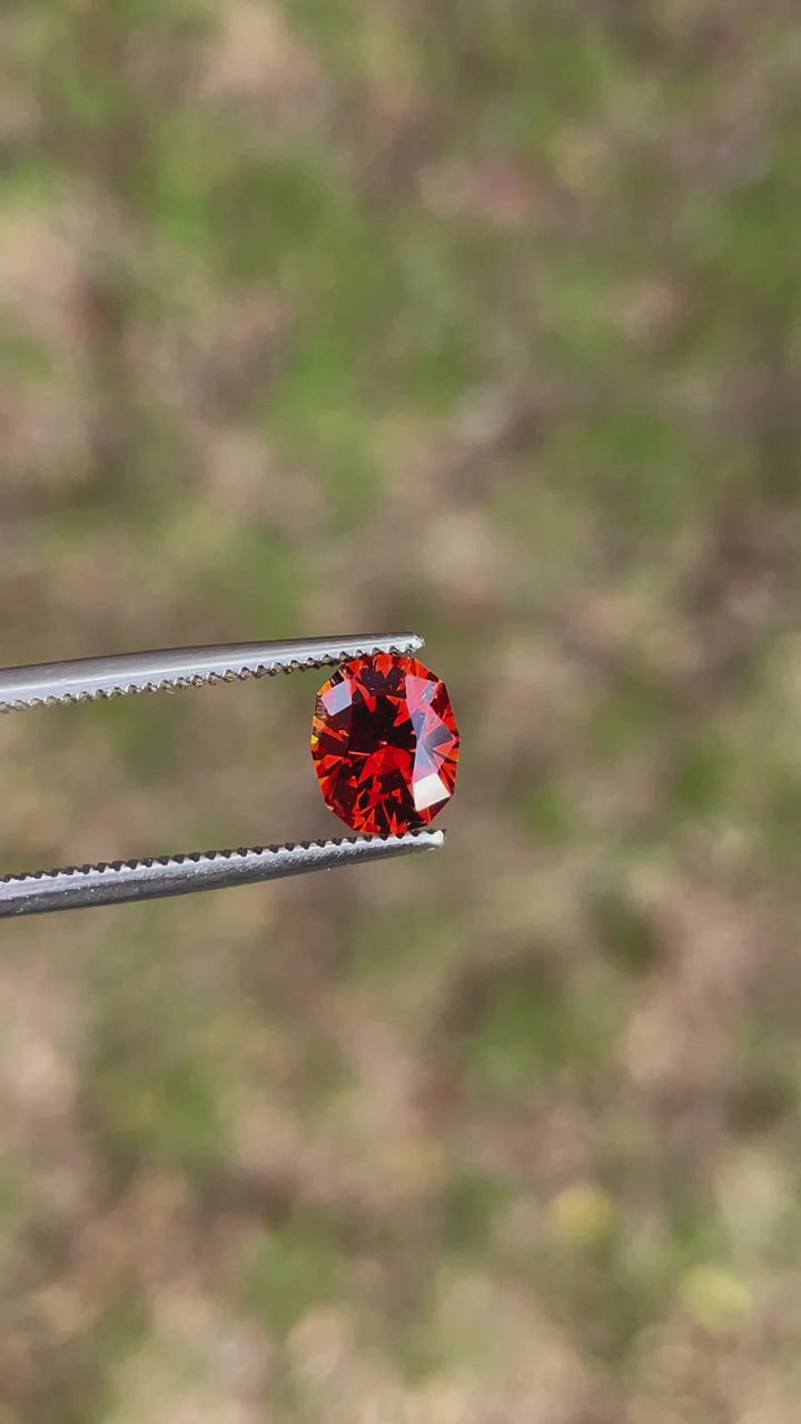 A rotating video showcasing the vibrant hues and geometric oval brilliance of a 1.68-carat Hessonite Garnet, sourced from Kenya.