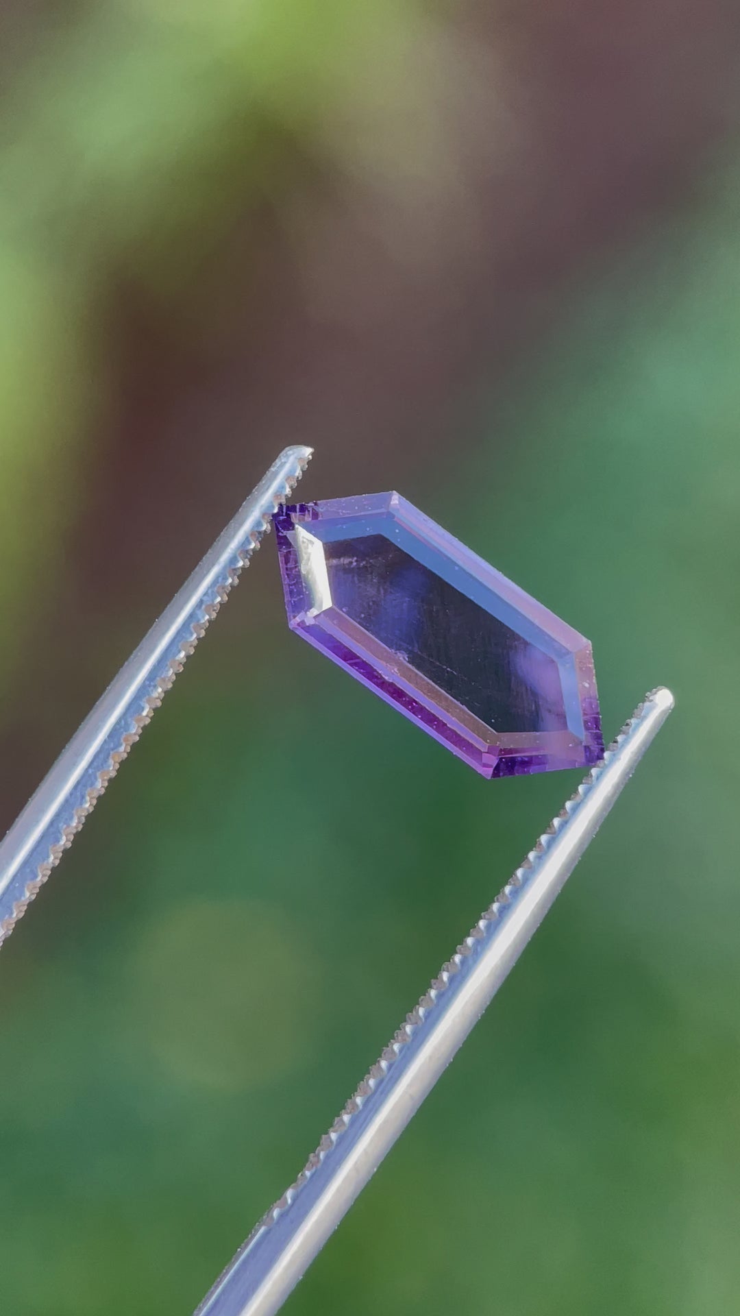 360-degree video of a 1.81 carat spinel gemstone, highlighting a hexagonal portrait step cut with vibrant purple and pink tones, untreated and from Sri Lanka.