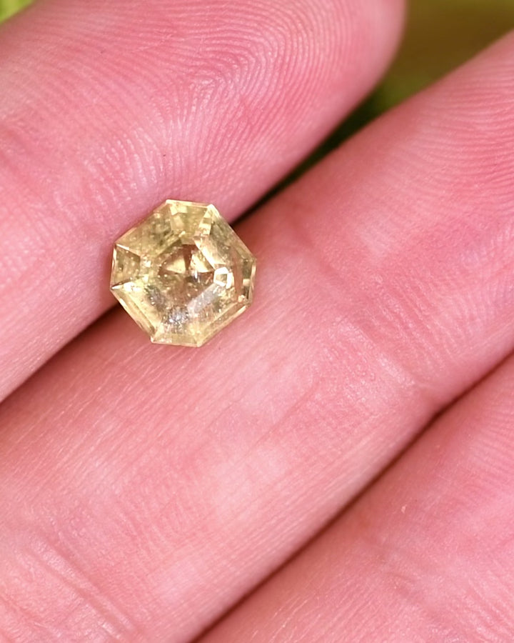 Macro video of 1.88 carat teal yellow sapphire turning slowly, showing vivid reflections, depth, and structure of its Asscher cut, untreated sapphire from Umba River Valley, Tanga, Tanzania.