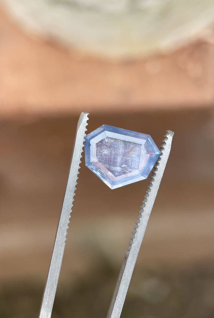 Rotating video of a 3.29 carat untreated sapphire from Sri Lanka, highlighting its serene seafoam and teal hues in a custom shield step cut.