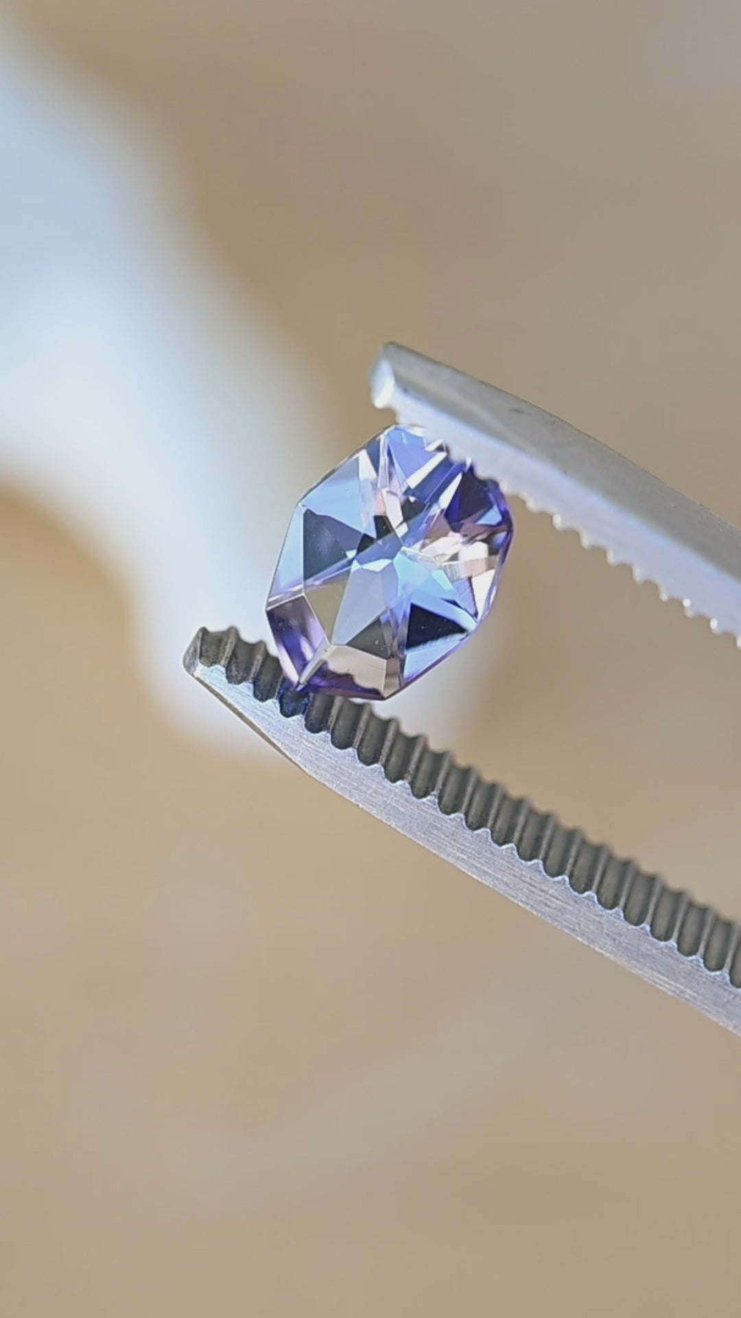Watch this natural 1.11 carat Merelani Hills tanzanite rotate in natural light, revealing its precision geometric marquise cut and beautiful shifts between purple, blue, teal, and gray.