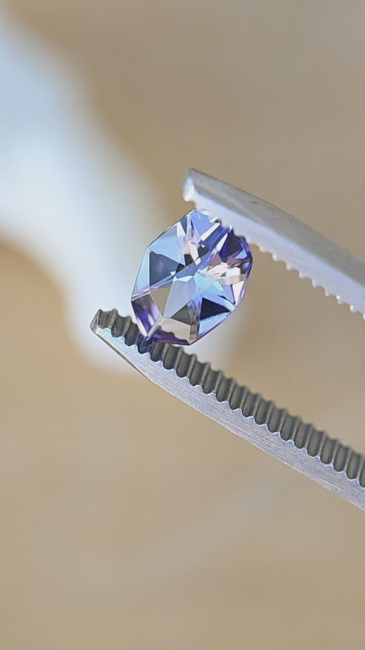 Watch this natural 1.11 carat Merelani Hills tanzanite rotate in natural light, revealing its precision geometric marquise cut and beautiful shifts between purple, blue, teal, and gray.