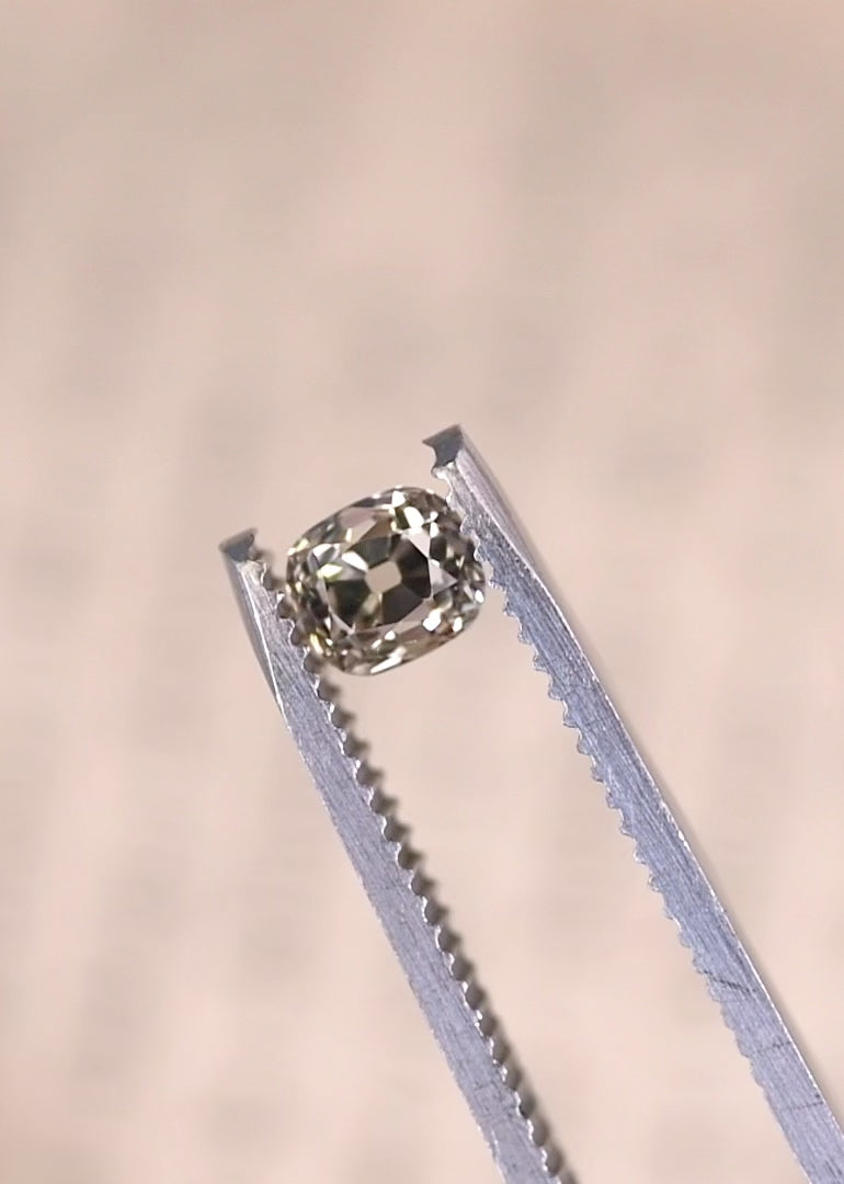 Rotating old mine cut cushion diamond showing chunky facets and antique brilliance.