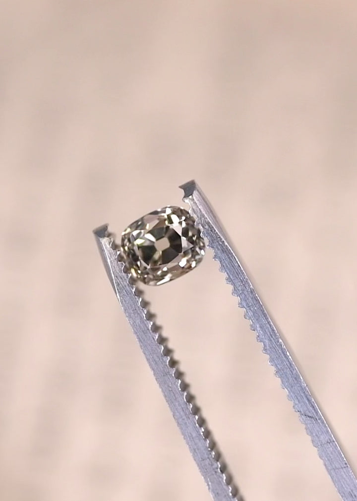 Rotating old mine cut cushion diamond showing chunky facets and antique brilliance.