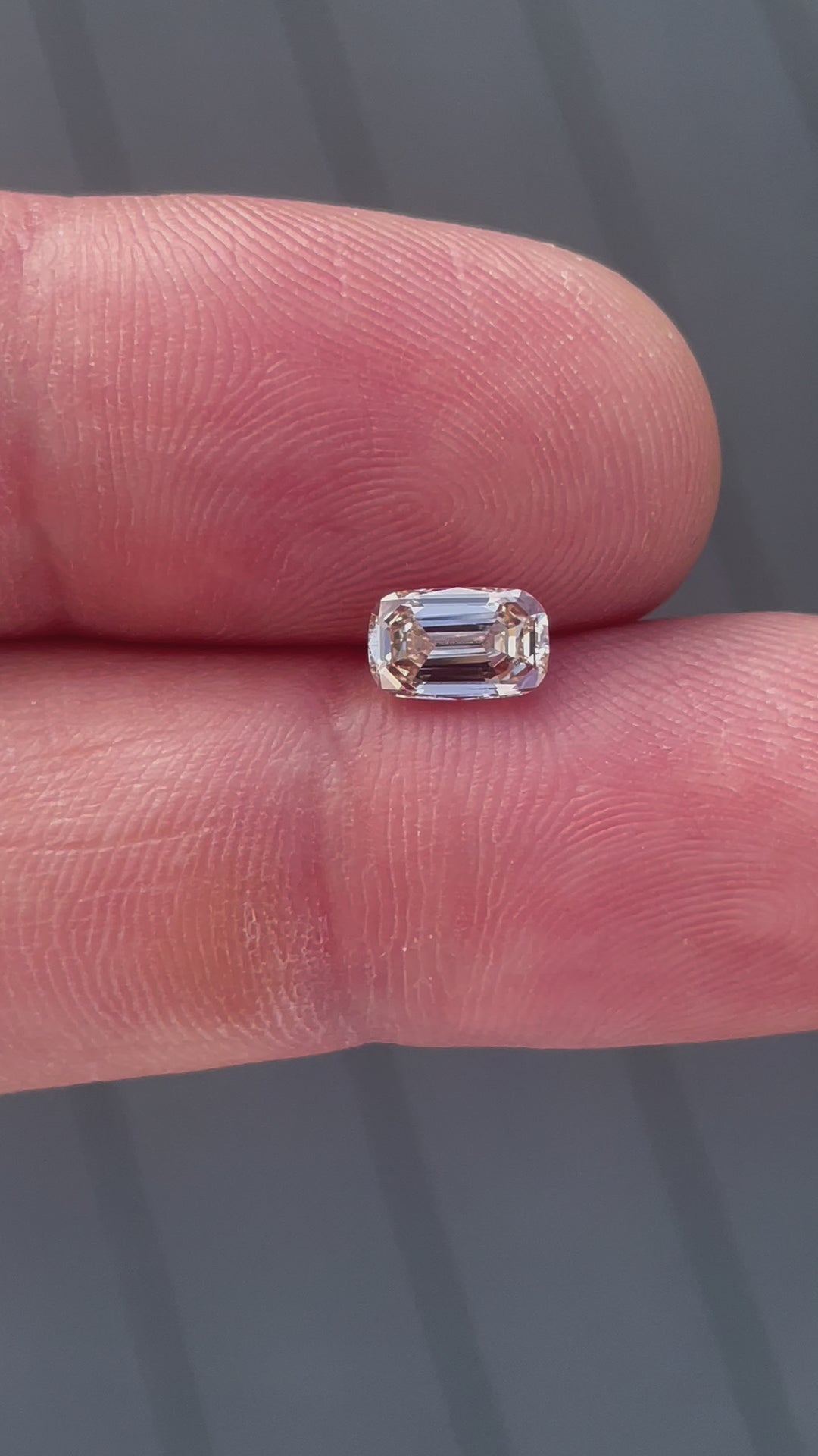 Close-up video showcasing the 1.02-carat champagne diamond’s step-cut facets, emphasizing its elegant sparkle and elongated shape.