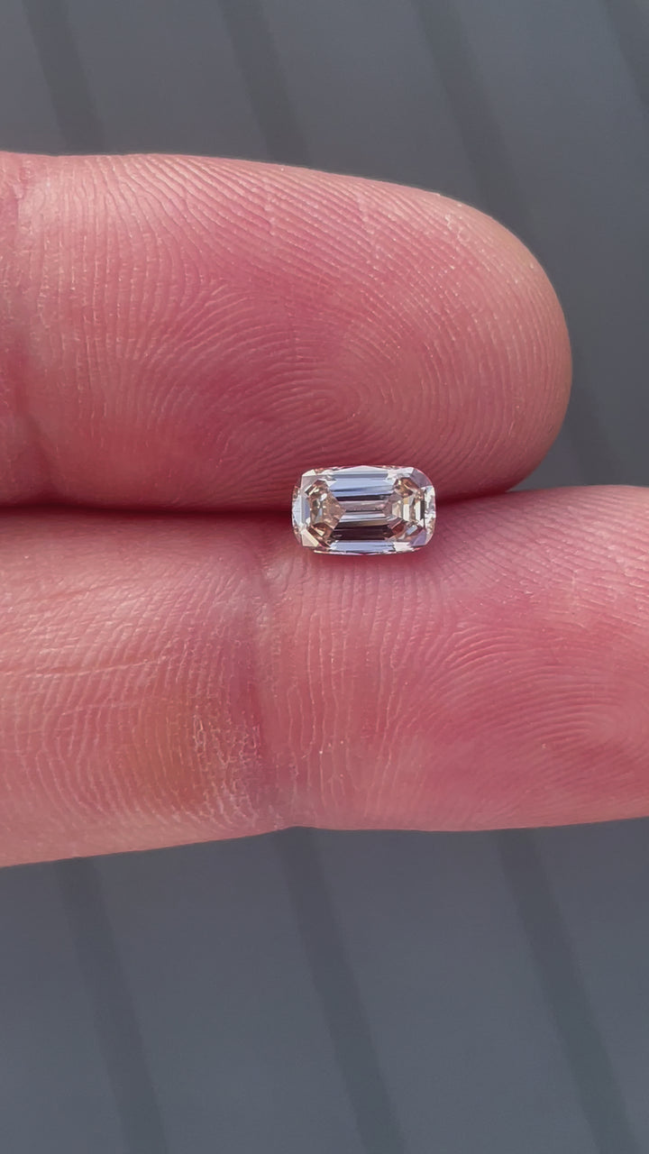 Close-up video showcasing the 1.02-carat champagne diamond’s step-cut facets, emphasizing its elegant sparkle and elongated shape.