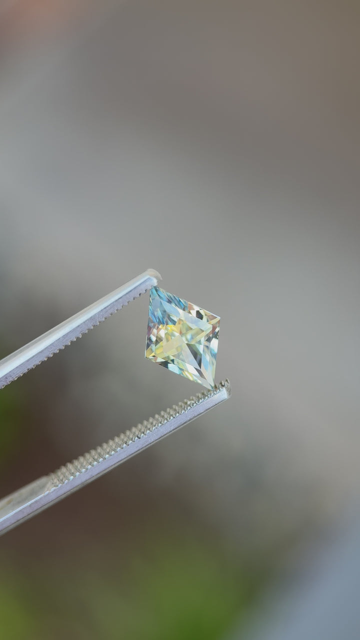 360° video of a 3.07ct untreated parti sapphire in custom lozenge mixed cut, displaying vibrant yellow and blue shifts under natural light
