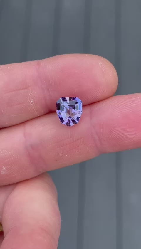 Detailed video capturing the stunning facets and rich color transitions of a 3.19-carat Tanzanite, showcasing its custom geometric shield cut and vibrant colors.
