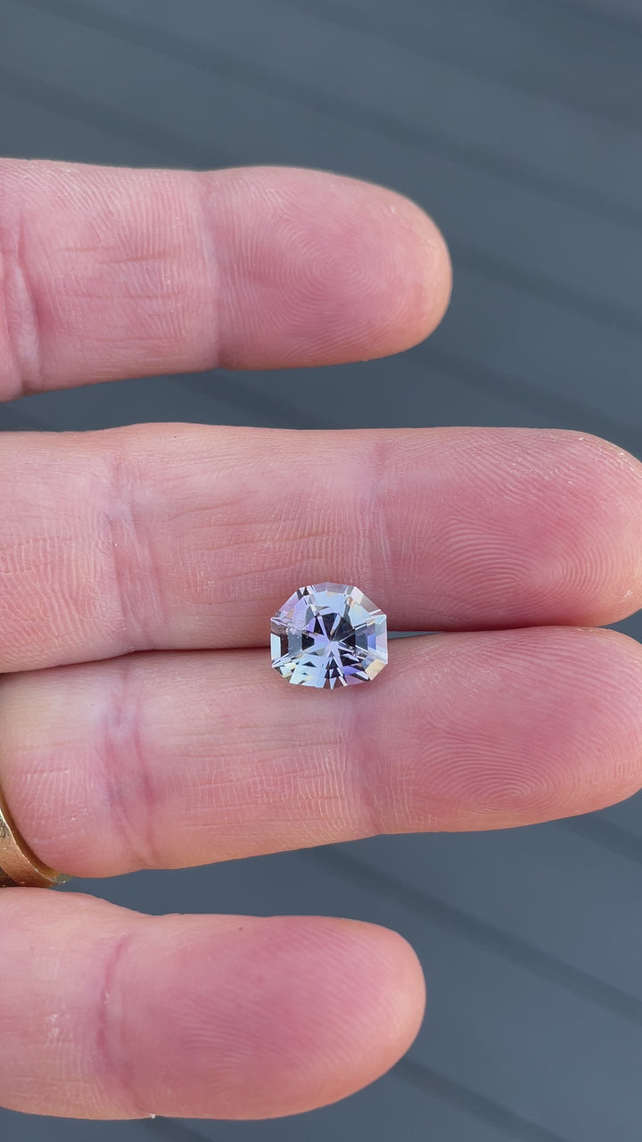 Video showcasing the brilliance and color play of a 3.33-carat Tanzanite from Tanzania in custom shield step cut, with shifting hues of mermaid, gray, lavender, and pink