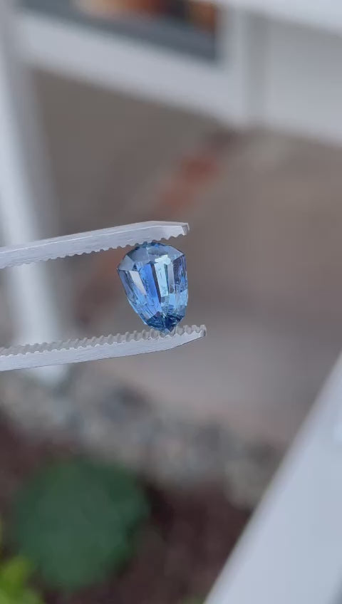 Detailed video displaying the exquisite craftsmanship of a 1.53-carat sapphire, emphasizing its custom shield step cut and parti colors of denim, cornflower, and teal.