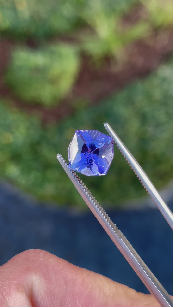 Close-up video of a 3.27-carat Tanzanite gemstone with a geometric cushion cut, featuring vivid ultra violet and purple colors. Ethically sourced from Merelani Hills, Tanzania.