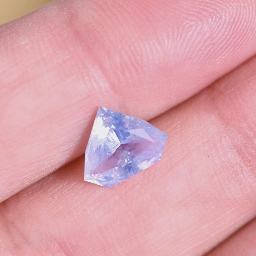 Rotating loose opalescent blue sapphire from Sakaraha Madagascar showing the soft glow and color shift of the geometric shield cut as it moves in light.