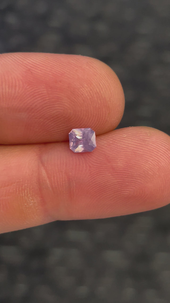 Video showcasing a 1.04 carat cushion cut sapphire gemstone, opalescent pink to purple, with untreated clarity and Sri Lankan heritage.