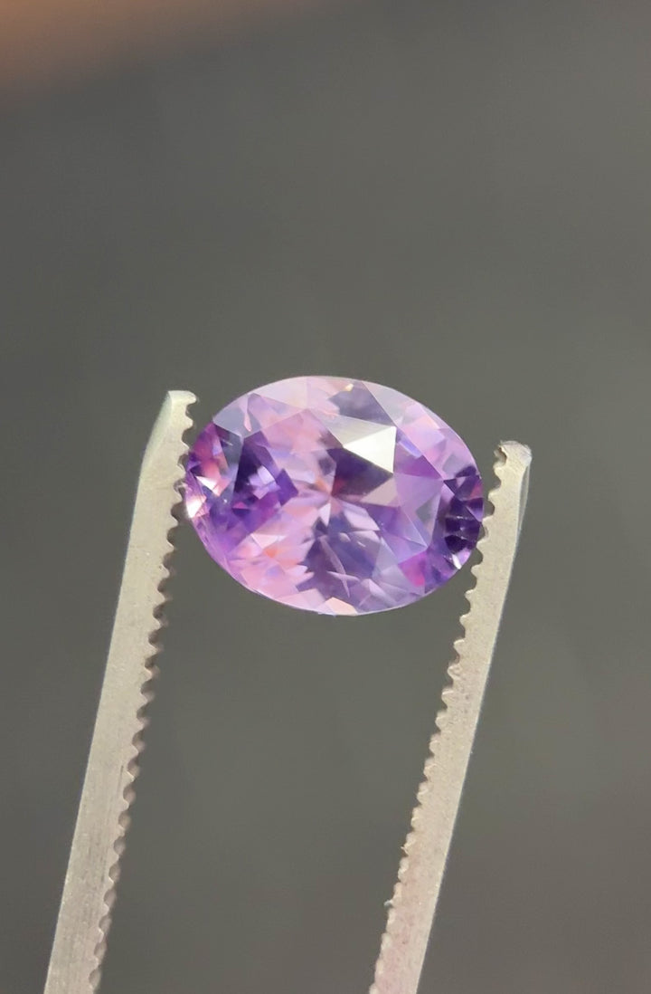 Video of 4.04 carat sapphire from Sakaraha, Madagascar rotating under natural light to show pink, violet, and purple hues in a precision oval cut.