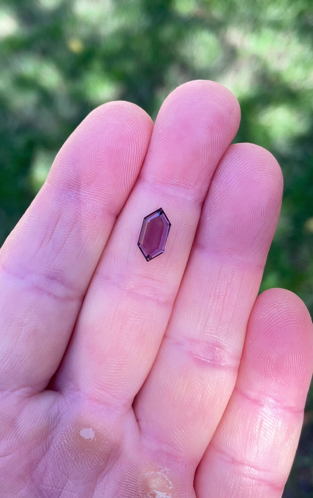 Video showing the luster and brilliance of a 1.77-carat Purple and Pink hexagonal step cut spinel under natural light.