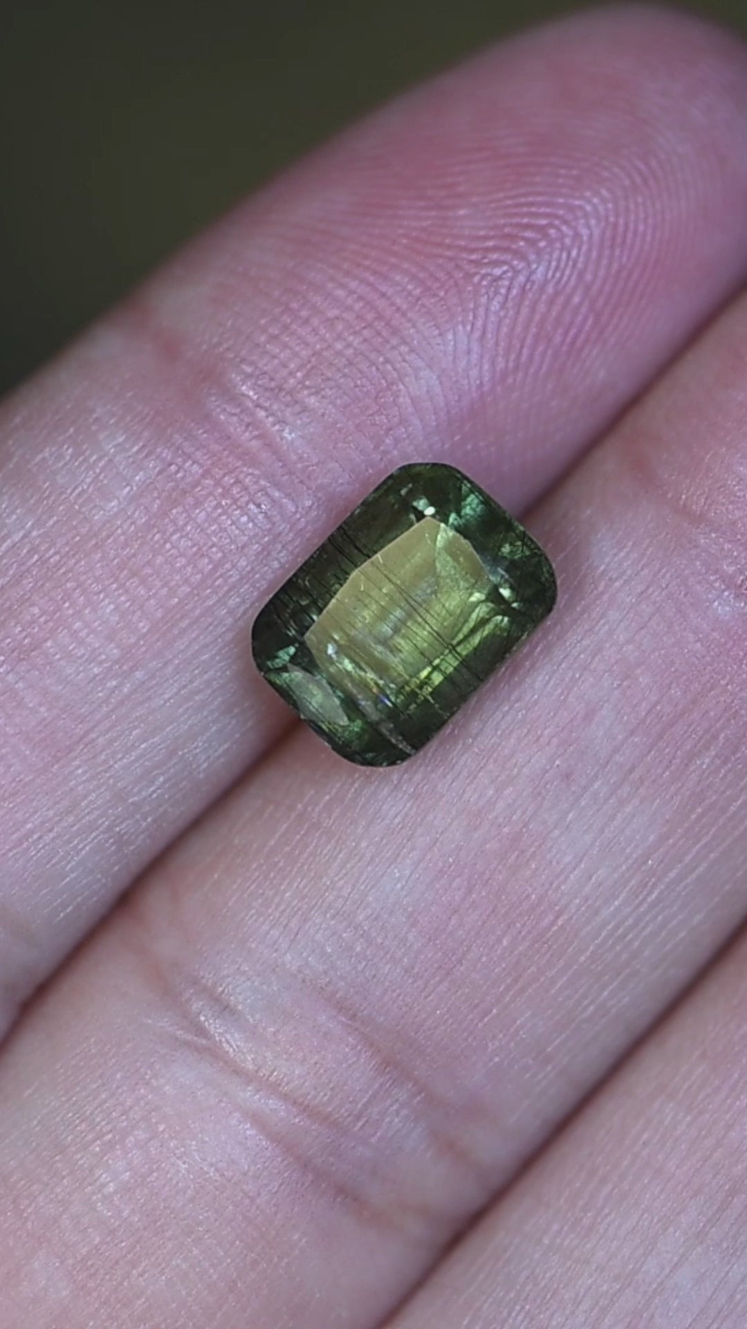 Experience this natural untreated Pakistan peridot in hand as its soft forest green color, elegant cushion mix cut, and intricate internal crystal structure become visible from every angle.