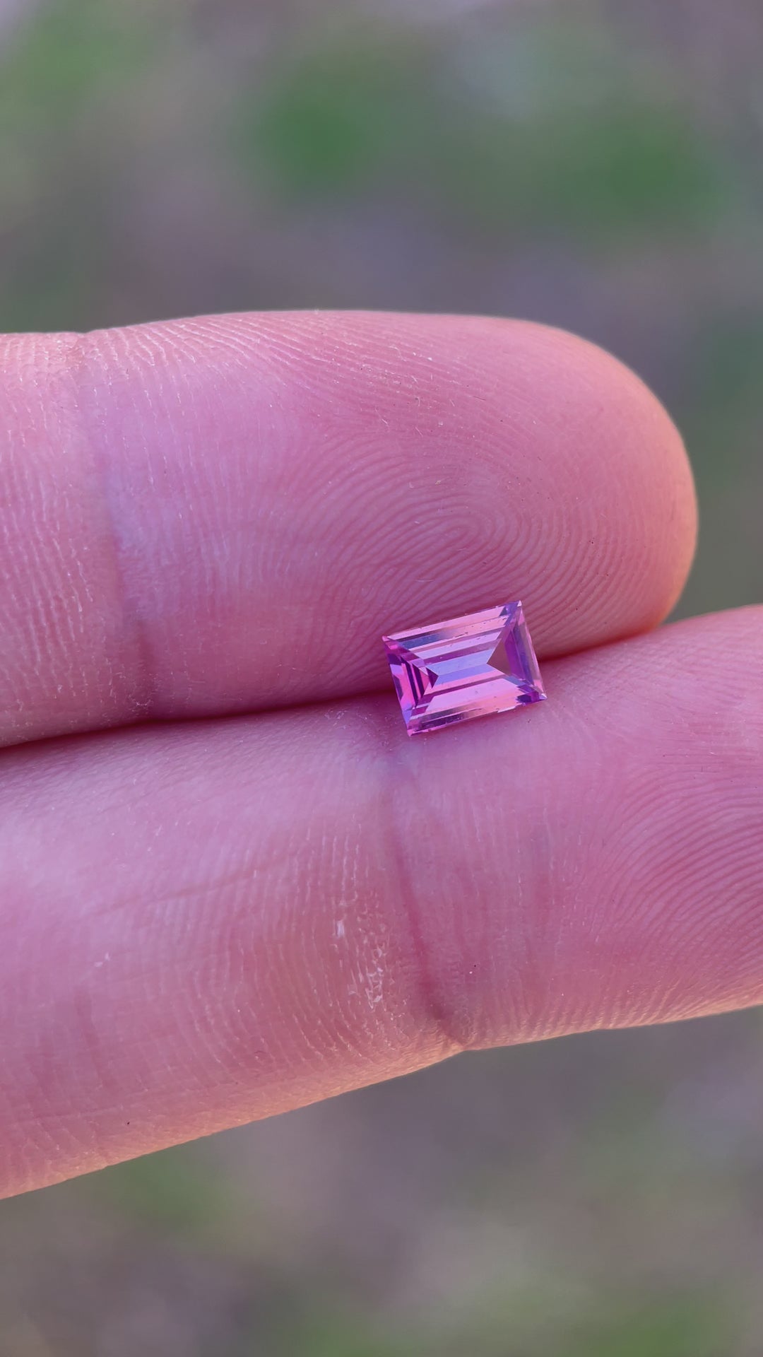 Interactive display of a 1.10 carat emerald cut sapphire, emphasizing its color depth and precision cut, ideal for high-end jewelry, from Sri Lanka.