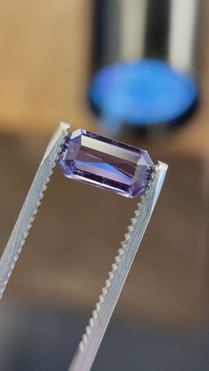 Video of unheated 1.41ct Umba River sapphire under varying light sources demonstrating violet-to-red fluorescence effect