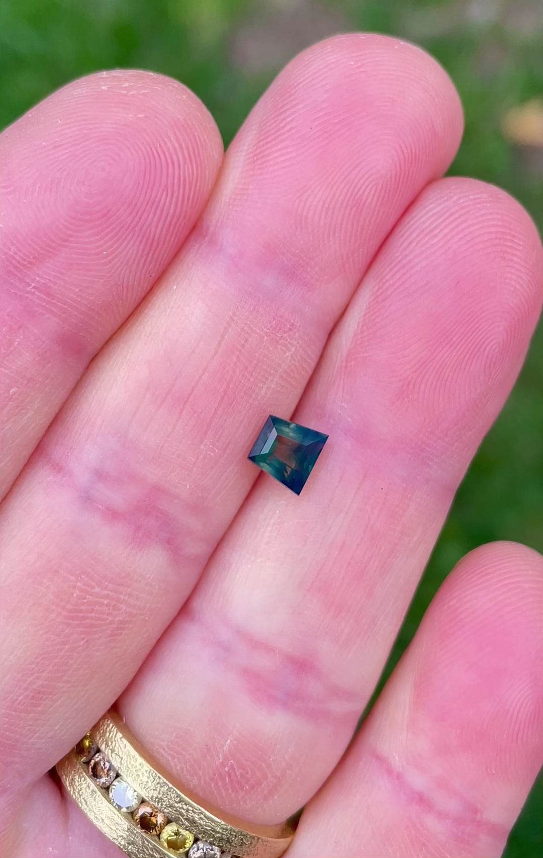 360-degree video of 1.15ct tapered baguette Australian sapphire revealing green, yellow, and blue color play in natural light