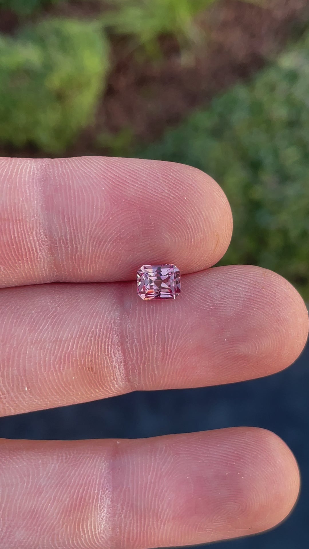 A video highlighting the brilliance and unique step-cut design of a 1.45-carat peach champagne garnet with natural peach and champagne tones.