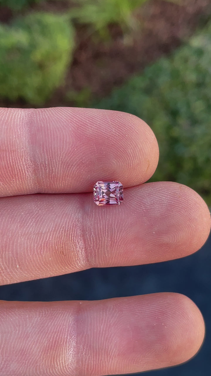A video highlighting the brilliance and unique step-cut design of a 1.45-carat peach champagne garnet with natural peach and champagne tones.