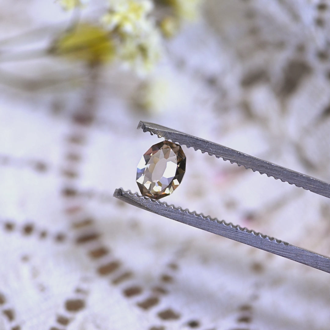 Loose 1.18 carat champagne Mughal cut diamond from South Africa turning in natural light, revealing its soft brown body color and internal brilliance.