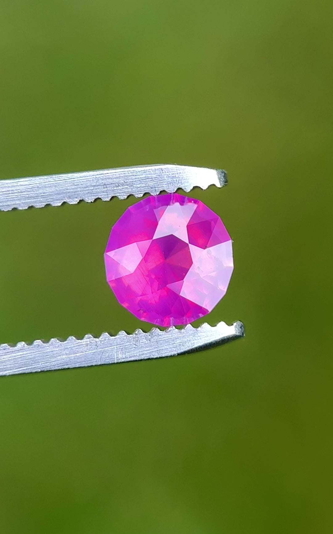 Rotating loose pink opalescent sapphire from Ratnapura Sri Lanka showing the brilliance and glow of the custom mix round cut as the pink color shifts in light.