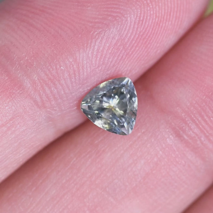 1.01CT Montana sapphire green yellow gray custom trillion cut rotating under natural light showing triangular brilliance and facet precision