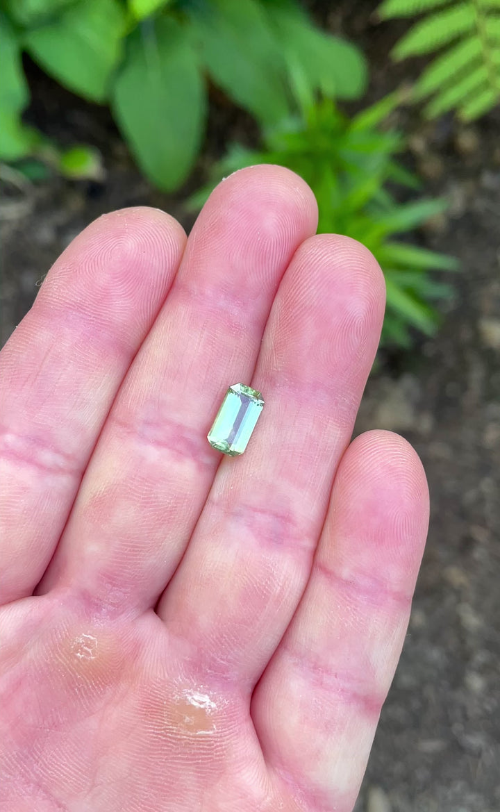Video showcasing light reflection across a 2.24-carat sapphire from Umba River with a mix of yellow, green, and teal hues.
