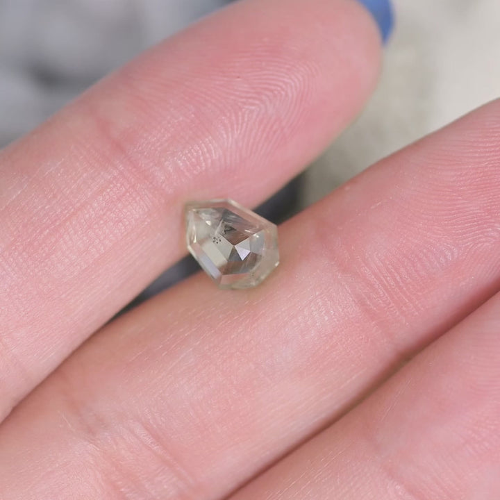 Rotating 1.82CT untreated Montana sapphire in teal and seafoam hues, custom shield rose cut gemstone shown in motion to highlight brilliance and faceting.