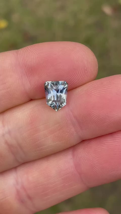 Close-up video capturing the stunning details of a 2.74-carat parti-colored Sri Lankan sapphire, emphasizing its intricate step cut and vibrant color transitions.