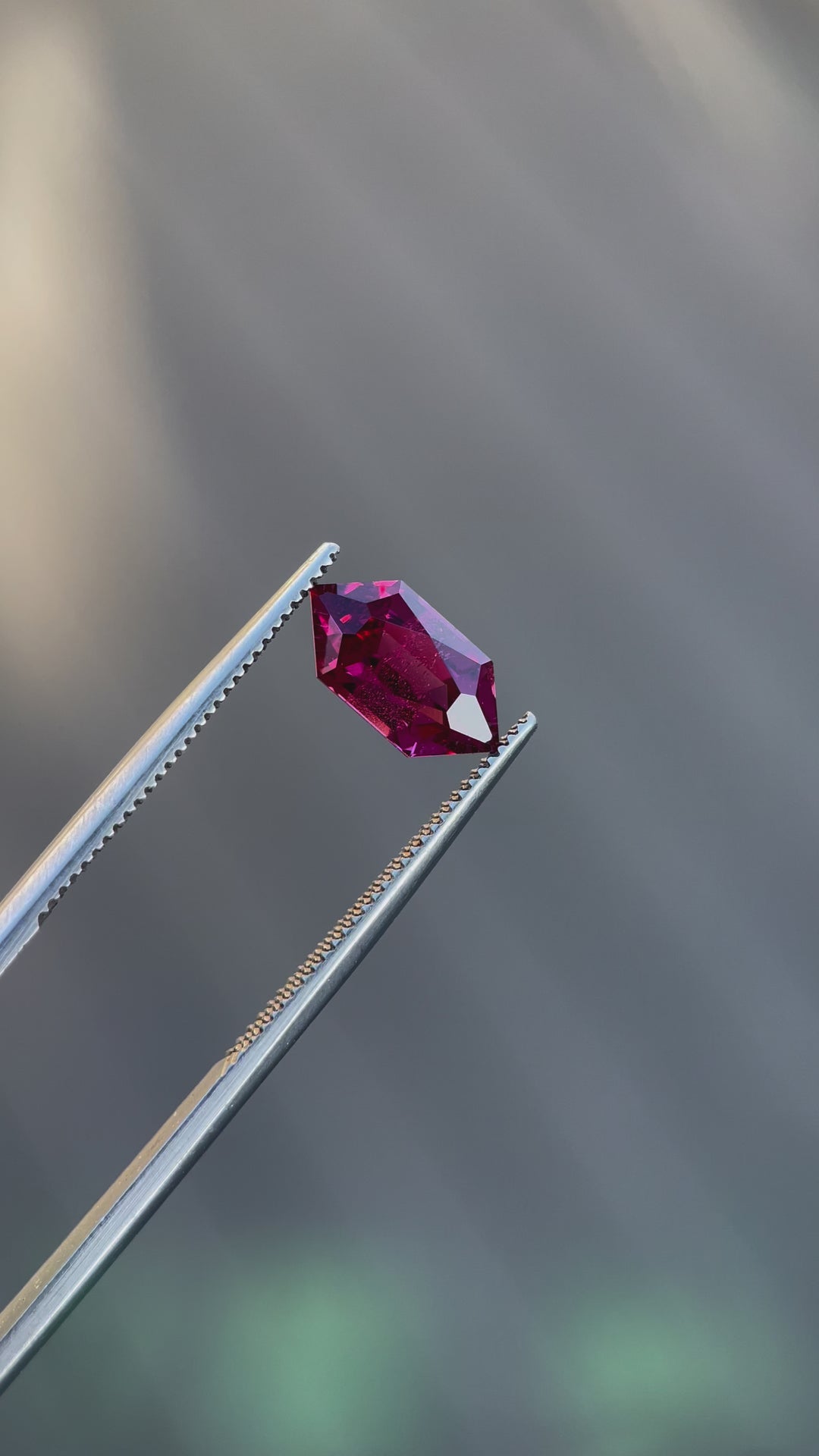 Video showcasing a vibrant red-purple garnet gemstone weighing 2.40 carats, featuring a unique hexagon cut and untreated natural clarity.