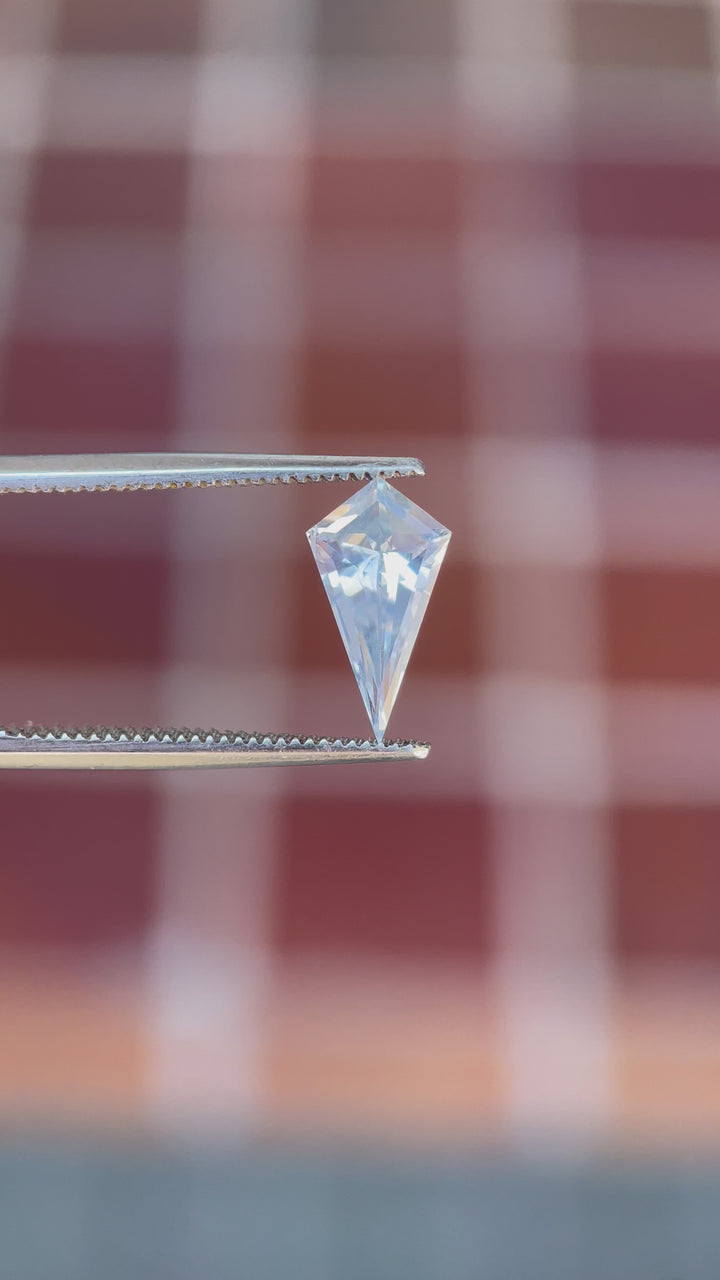 Captivating footage of a geometric step cut kite sapphire, 1.66 carats, as it sparkles under ambient light, emphasizing its unique color palette and Sri Lankan origin.