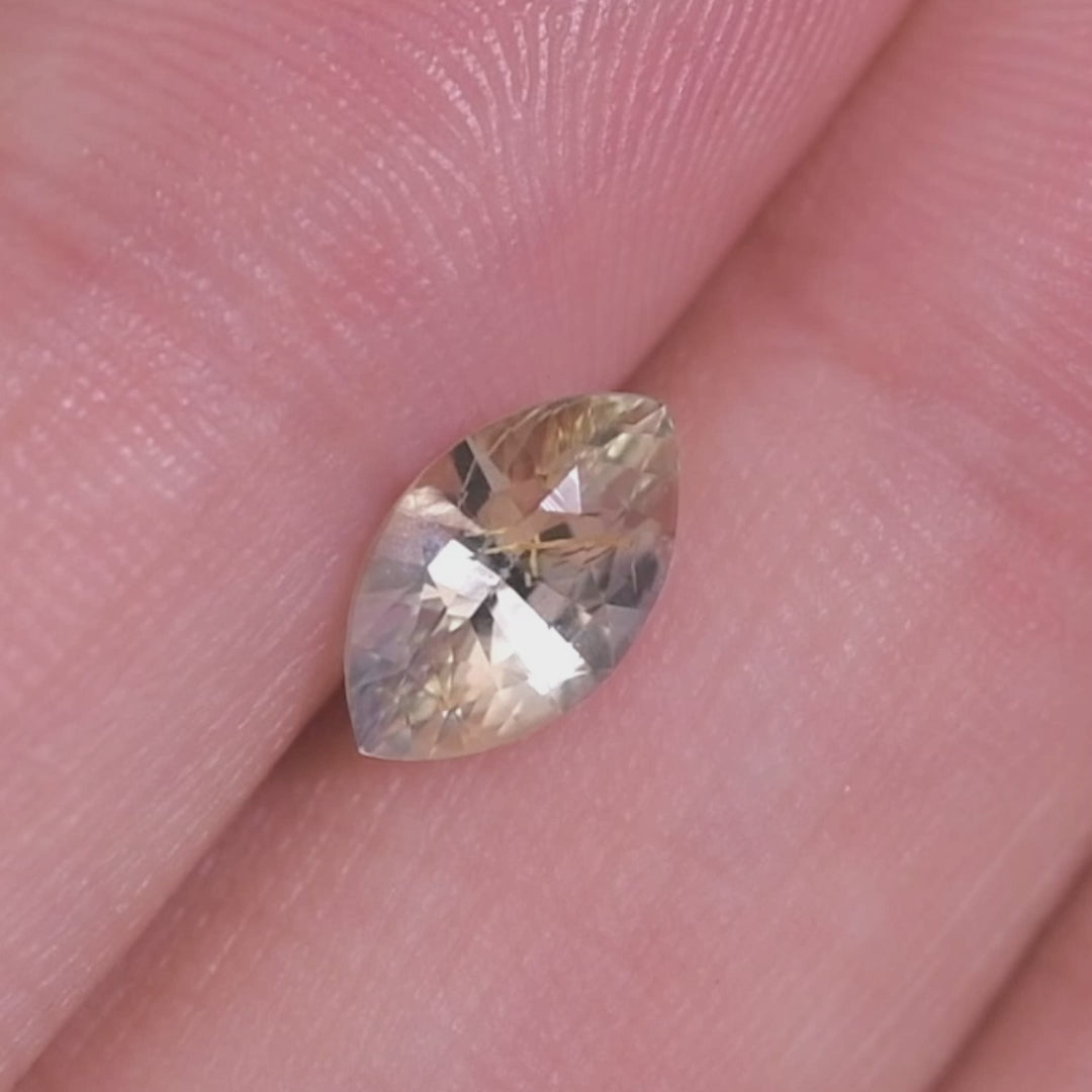 Rotating loose parti yellow, blue, and green marquise mixed cut sapphire from Sakaraha Madagascar showing brilliance and color zoning as it moves in the light.