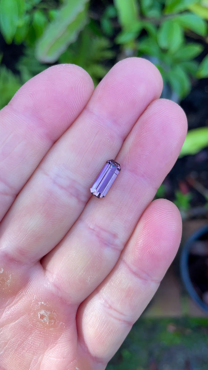 Close-up video of a 2.12-carat Tanzanite exhibiting pastel peach, lavender, and pink hues while rotating under natural light.
