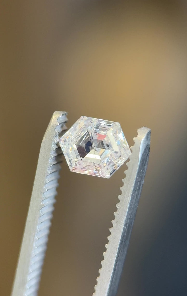 Video of a 1.01 carat G color I2 clarity diamond from Gahcho Kué, Canada, rotating under natural light to reveal the precision of its hexagonal step cut and internal inclusions, untreated and ethically sourced.