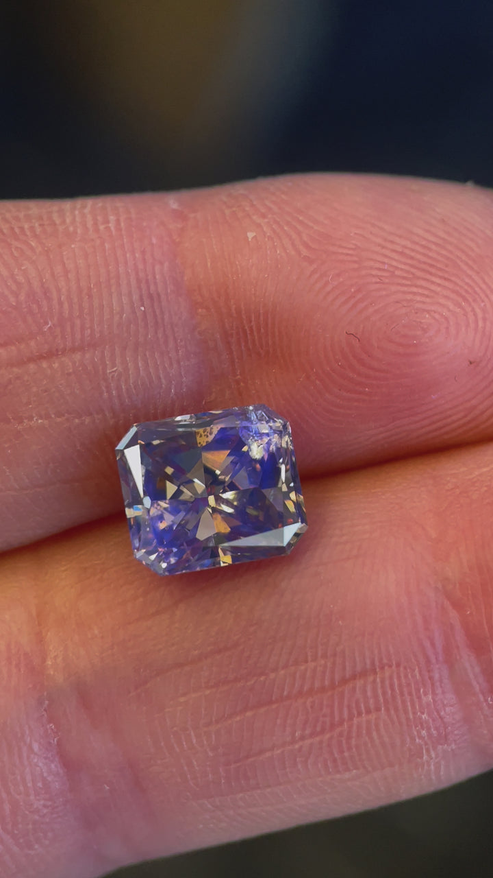 A high-resolution video of a 3.68-carat Argyle Mines diamond, highlighting its warm champagne tone and scintillating step-cut reflections.