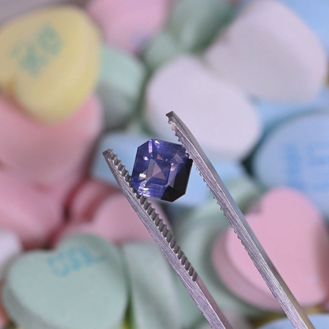 Rotating loose lavender periwinkle sapphire from Ratnapura Sri Lanka showing the brilliance and color shift of the precision Asscher cut as the gemstone moves in light.