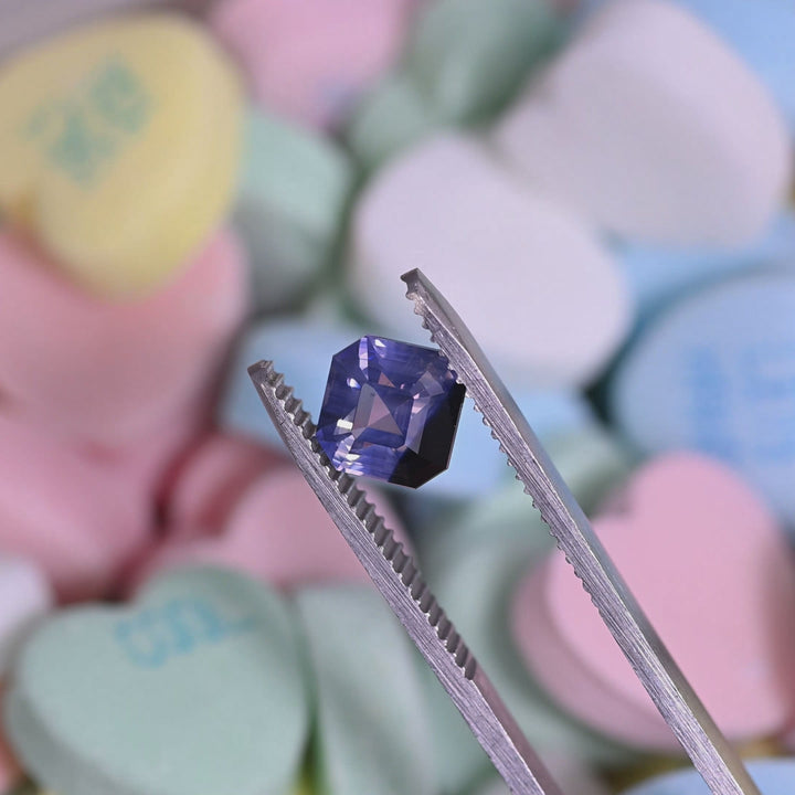 Rotating loose lavender periwinkle sapphire from Ratnapura Sri Lanka showing the brilliance and color shift of the precision Asscher cut as the gemstone moves in light.