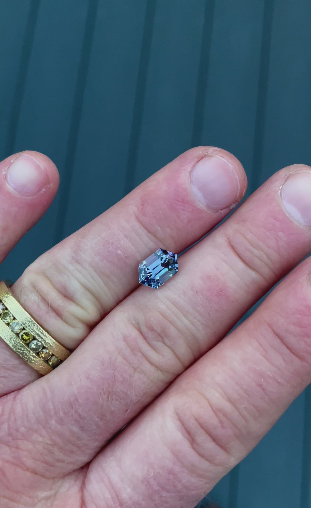 A high-resolution video of a rare 2.08-carat hexagonal step-cut Tanzanite from Merelani Hills, Tanzania, revealing its natural teal and violet color transitions under different lighting conditions.