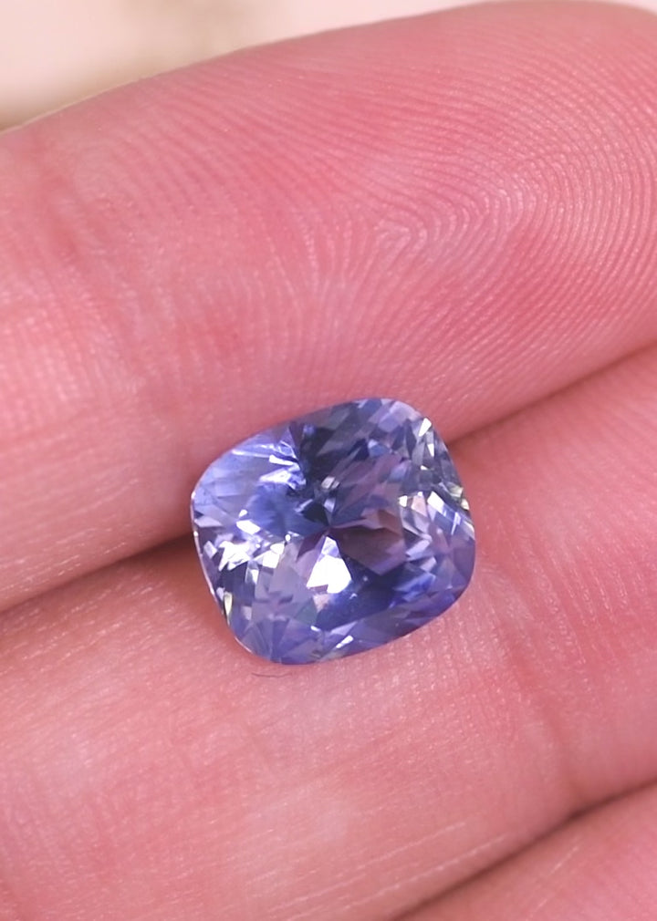 Rotating loose gradient cornflower blue sapphire from Sakaraha Madagascar showing the brilliance and color gradient of the precision elongated cushion mixed cut.