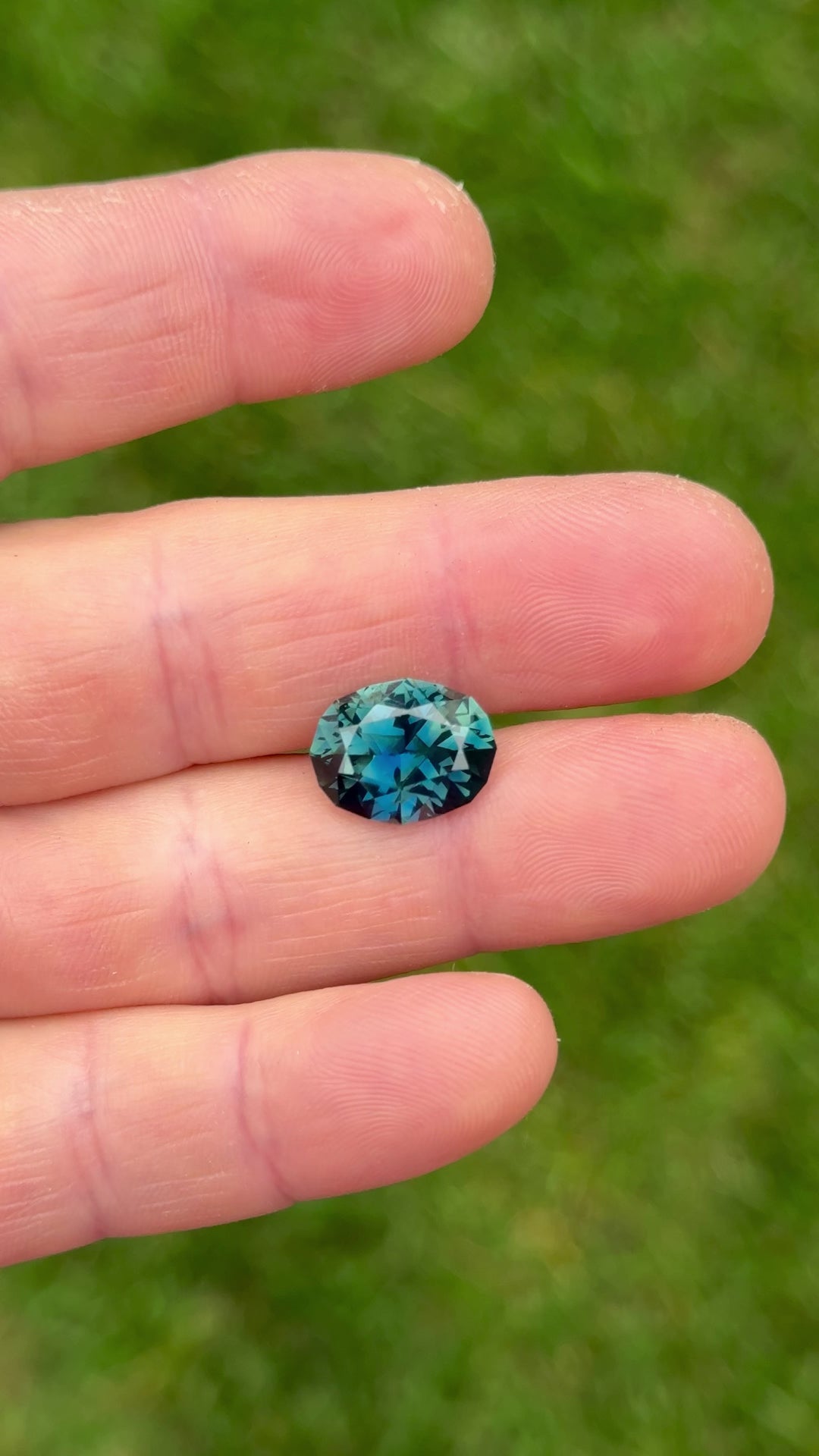 High-clarity close-up video of untreated 7.75ct teal-blue sapphire showcasing the depth of color and light performance in motion.