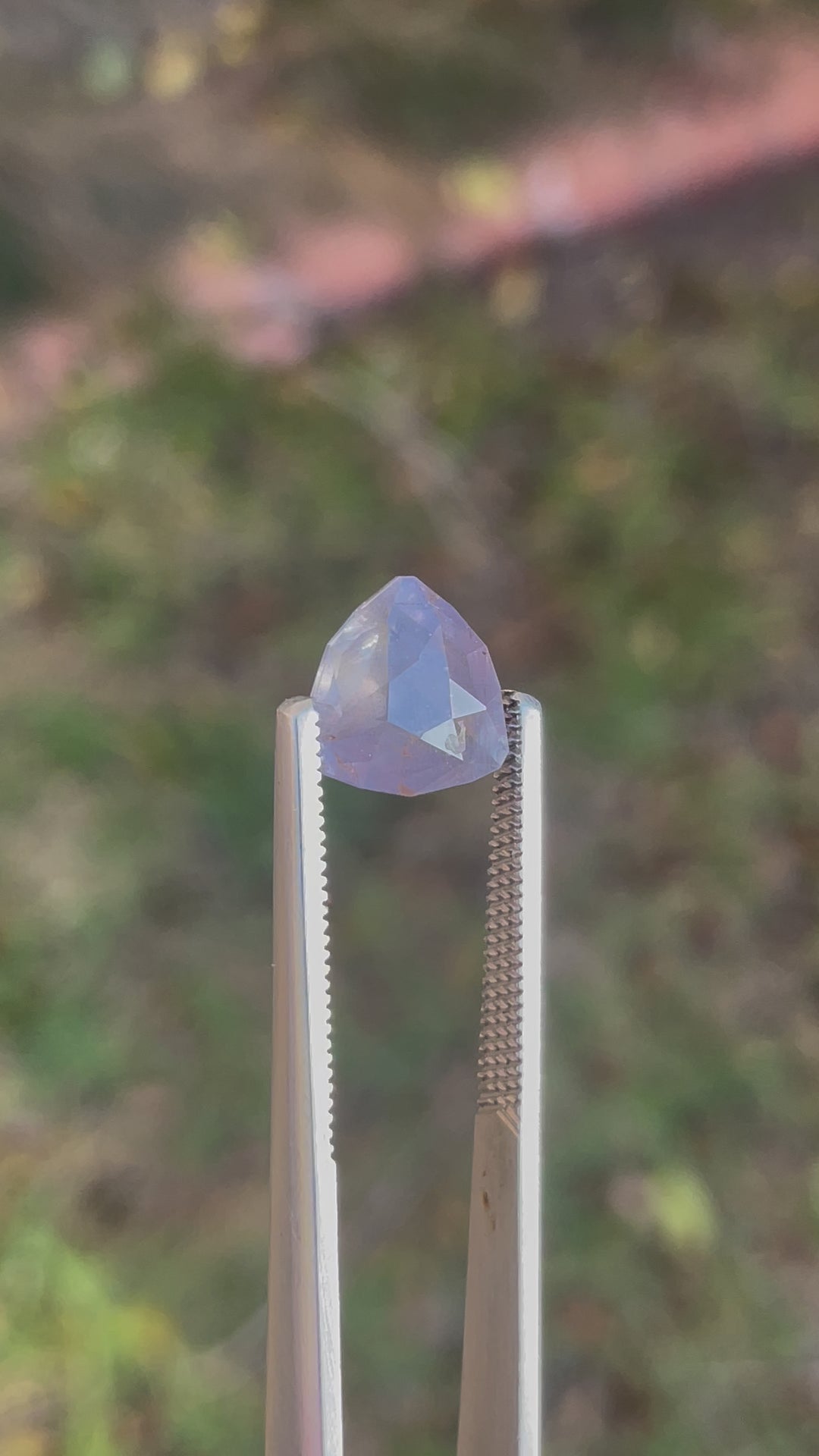 A close-up video of a 4.19-carat sapphire, revealing its transition between gray, teal, and yellow tones under natural lighting. Ethically sourced and untreated from the Umba River, Tanzania.