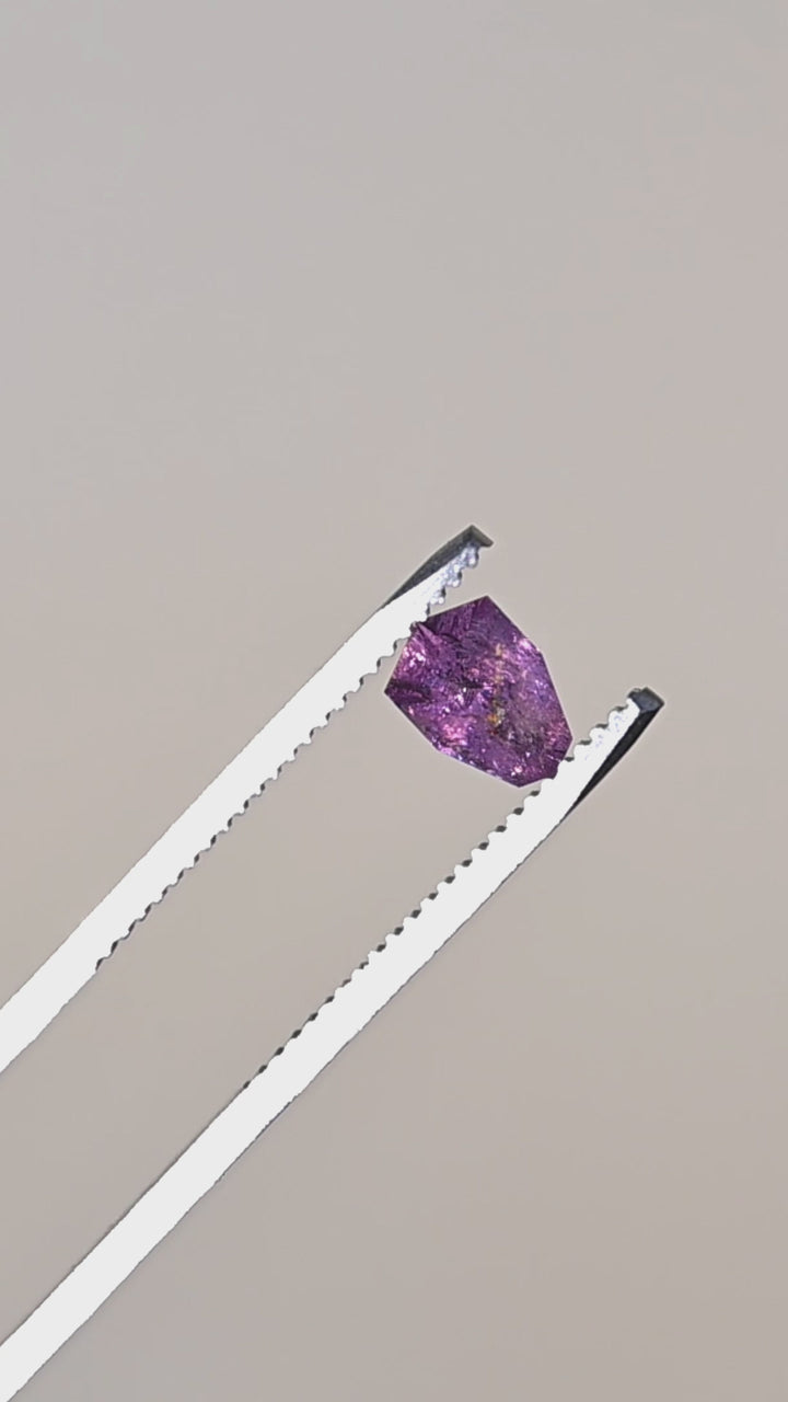See this natural untreated Colombian sapphire in sunlight as its soft rose pink hues and custom shield cut reveal delicate flashes of blush, lavender, and crystalline brilliance.